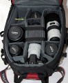 Vanguard Kenline 54\n\nFoto von Gerhard Bertling - Danke fr das Mail.\n\nKommentar des Nutzers:\n\nAuf den Rucksack "Kenline54" der Firma Vanguard bin ich auf der Photokina aufmerksam geworden. Die Beschaffung war nicht ganz einfach, da es bisher keinen Deutschen Distributor gibt. Demnchst wird das die Firma Compit in Lengerich bernehmen (http://www.compit.biz). Ansonsten kann man sich unter http://www.guardforce.net/indexe.asp informieren.\n\nVanguard stellt seit 1986 Foto- und Videozubehr her. Die Qualitt ist mit LowePro durchaus vergleichbar, bei vielen kleine innovativen Details ist Vanguard sogar im Vorteil. Mit dem Rucksack bin ich momentan vollkommen zufrieden, der Tragekomfort ist ausgezeichnet. Der Beckengurt ist breit und bequem, sitzt bei meiner Gre (1,90m) allerdings schon fast etwas zu hoch.\nFr Menschen > 190cm ist der Rucksack daher eher weniger geeignet. \n\nAuenabmessungen (BxTxH): 35 x 32 x 50 cm (vergleichbar mit LowePro Nature Trekker aber nicht ganz so tief) Innenbereich 29 x 12,5 x 42 cm, individuell aufzuteilen mit verstellbaren Wnden, die mit Alcantara bezogen sind.\nNotebooktasche vorhanden.\nStativ kann seitlich angebracht werden (Tasche und 2 Spanngurte).\nDehnbare Daypack-Tasche in der Klappe, fasst problemlos zwei 1,5Liter-PET-Flaschen, Kleidung etc.\nWeitere Organizer-Tasche in der Klappe fr flache Gegenstnde (Papiere, Schreibmaterial etc.) Wasserdichte Regenhaube mit reflektierender Rckseite (UV-Schutz).\nMaterial: 840x840D Nylon, 600D Polyester, 420D Nylon.\nRckseite und Gurte sind extrem gut gepolstert und bieten einen sehr hohen Tragekomfort.